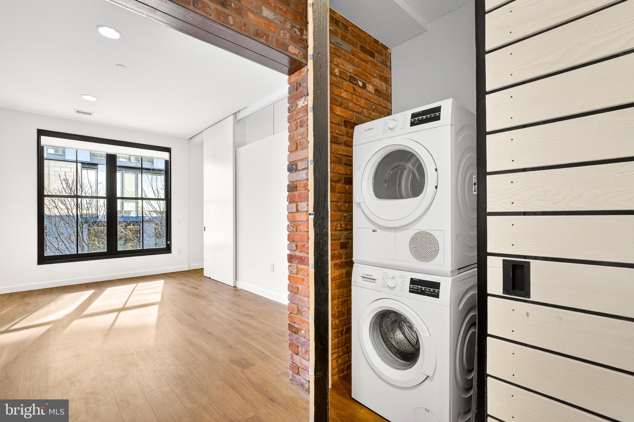 57 N Street Northwest, Unit 302 Washington, DC 20001 - Photo 13 of 34 a view of a bedroom with washer and dryer