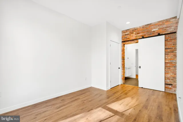a view of a room with wooden floor