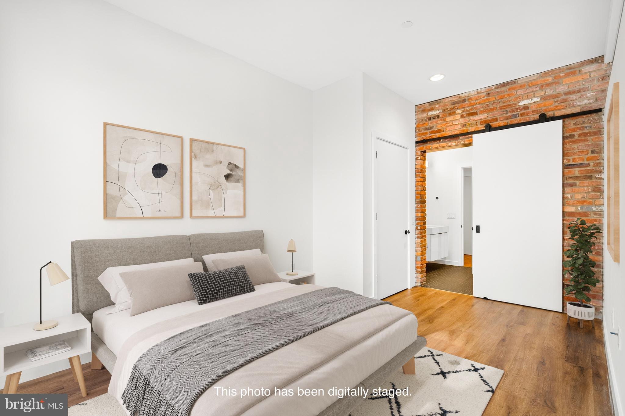 57 N Street Northwest, Unit 302 Washington, DC 20001 - Photo 17 of 34 a bedroom with a bed and wooden floor
