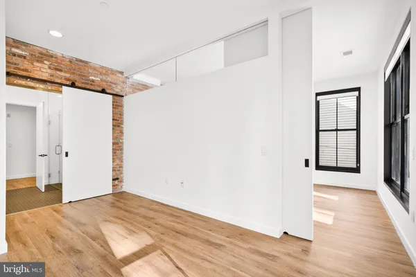 a view of a room with wooden floor