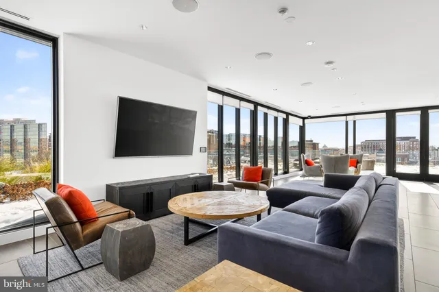 a living room with furniture and a floor to ceiling window