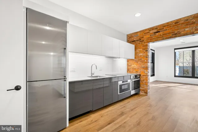 a kitchen with stainless steel appliances granite countertop a sink a stove and oven