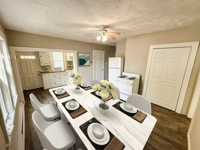 a view of a dining room with furniture and wooden floor