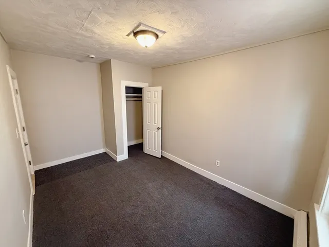 an empty room with a empty space and windows