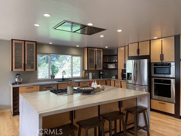 3402 Buttermilk Lane Arcata, CA 95521 - Photo 18 of 48 a kitchen with stainless steel appliances granite countertop a table chairs sink refrigerator and microwave