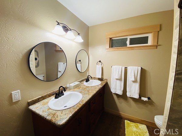 3402 Buttermilk Lane Arcata, CA 95521 - Photo 27 of 48 a bathroom with a granite countertop sink and a mirror