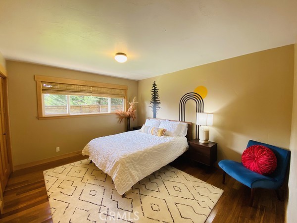 3402 Buttermilk Lane Arcata, CA 95521 - Photo 46 of 48 a bedroom with a bed and wooden floor