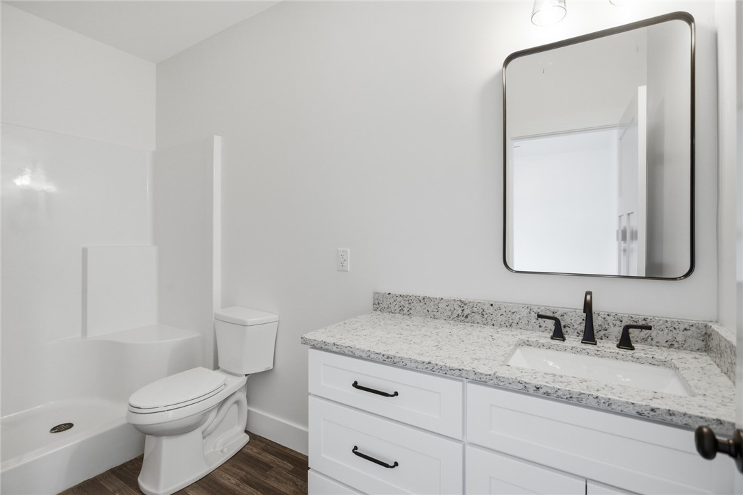 115 Riley Street Westminster, SC 29693 - Photo 16 of 46 This bright bathroom features a modern vanity with elegant countertops, perfect for daily routines.