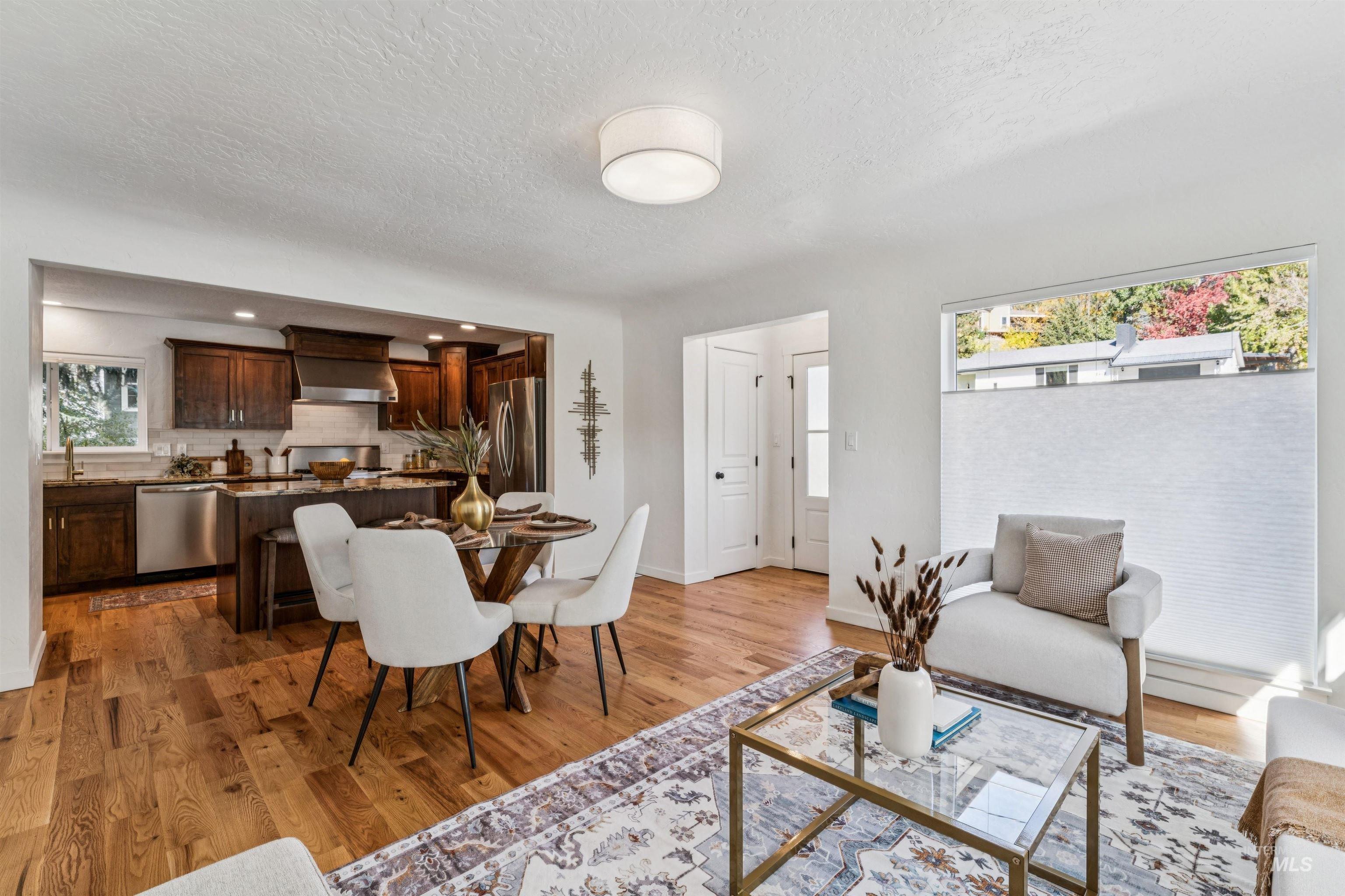 2419 West Hill Road Boise, ID 83702 - Photo 11 of 50 Dining room featuring a textured ceiling and light wood-style flooring