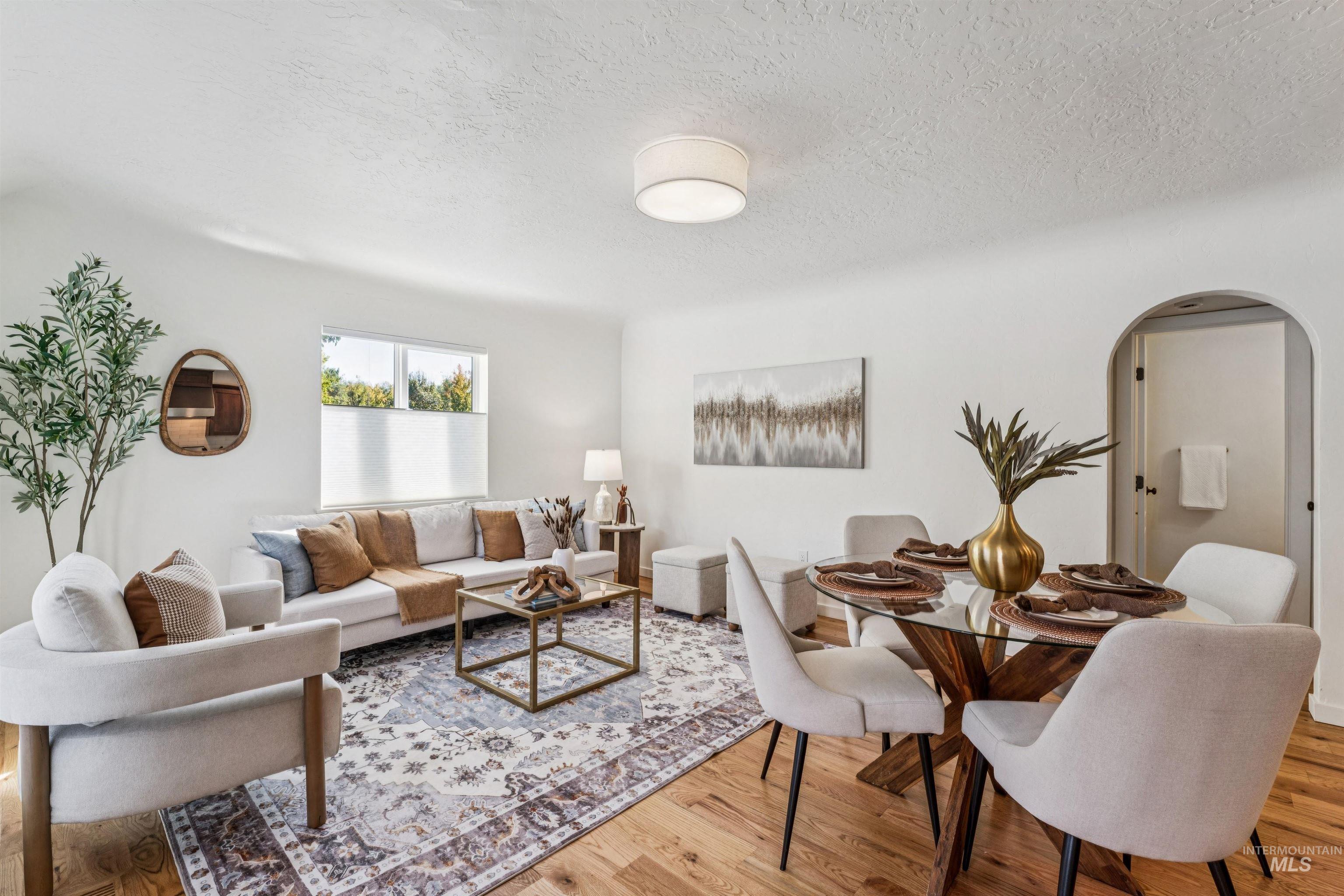 2419 West Hill Road Boise, ID 83702 - Photo 14 of 50 Great room area with arched walkways, a textured ceiling, and light wood-type flooring