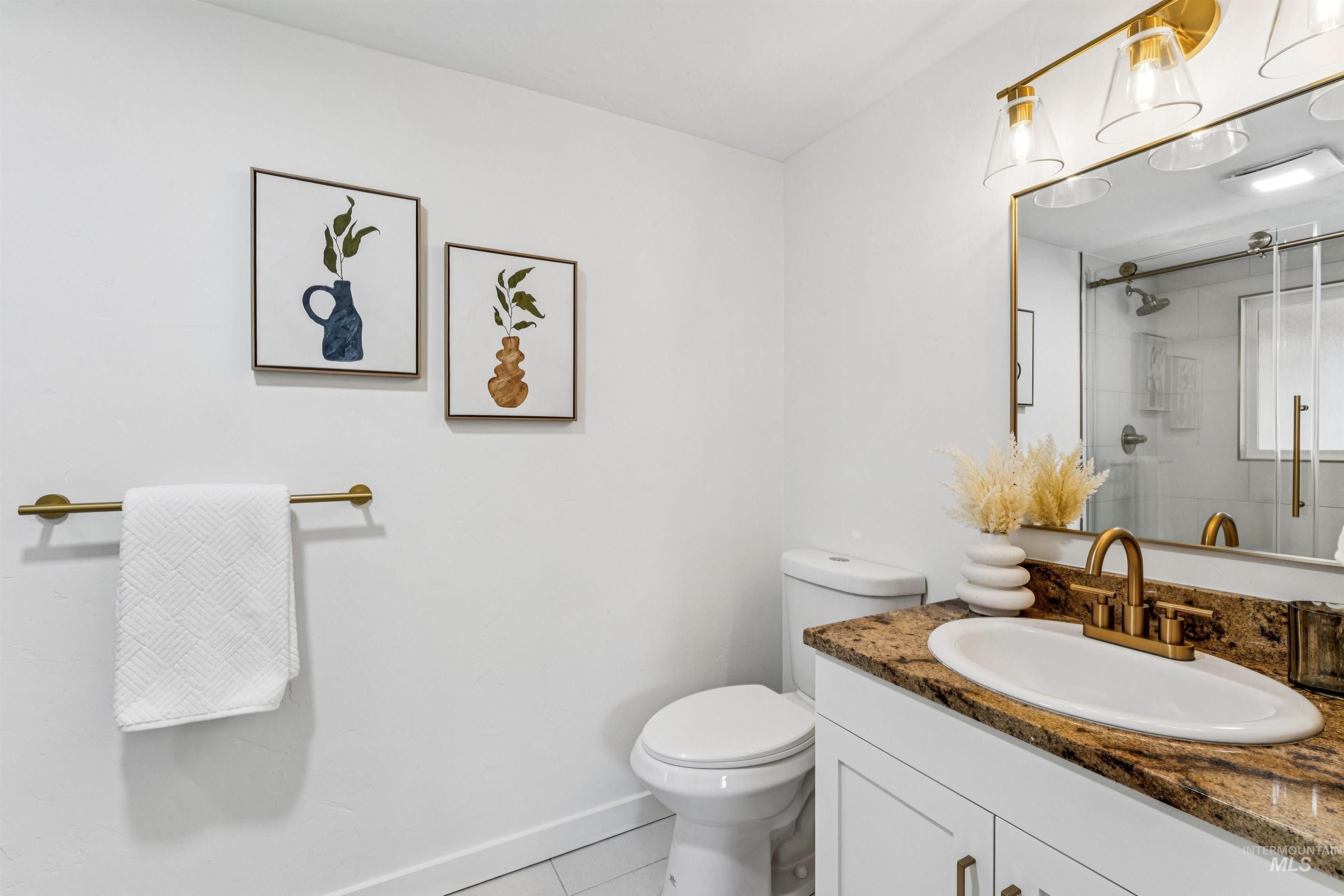 2419 West Hill Road Boise, ID 83702 - Photo 18 of 50 Primary bath with light tile patterned flooring, vanity, and a stall shower