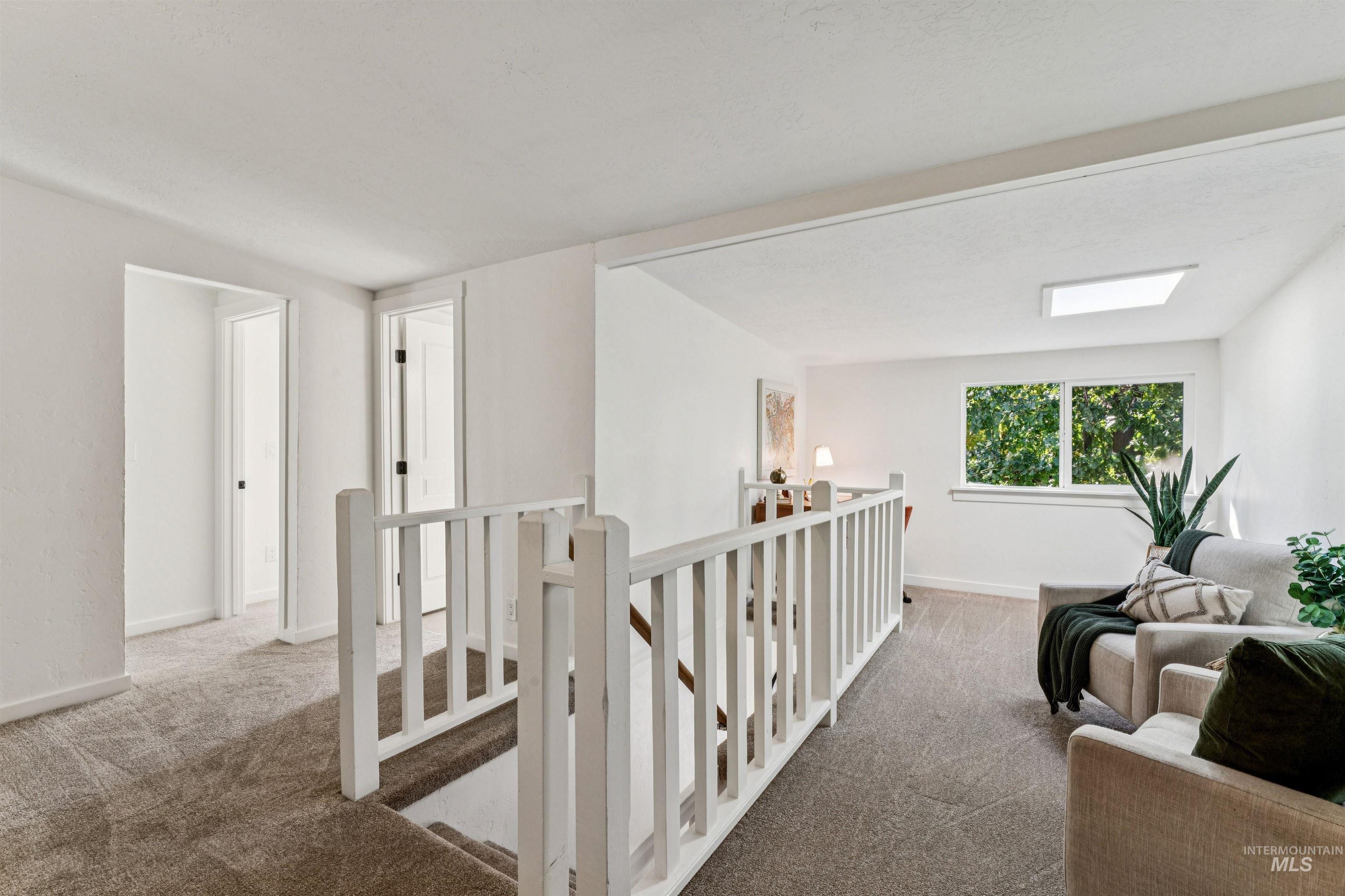 2419 West Hill Road Boise, ID 83702 - Photo 22 of 50 Hallway featuring an upstairs landing and carpet flooring