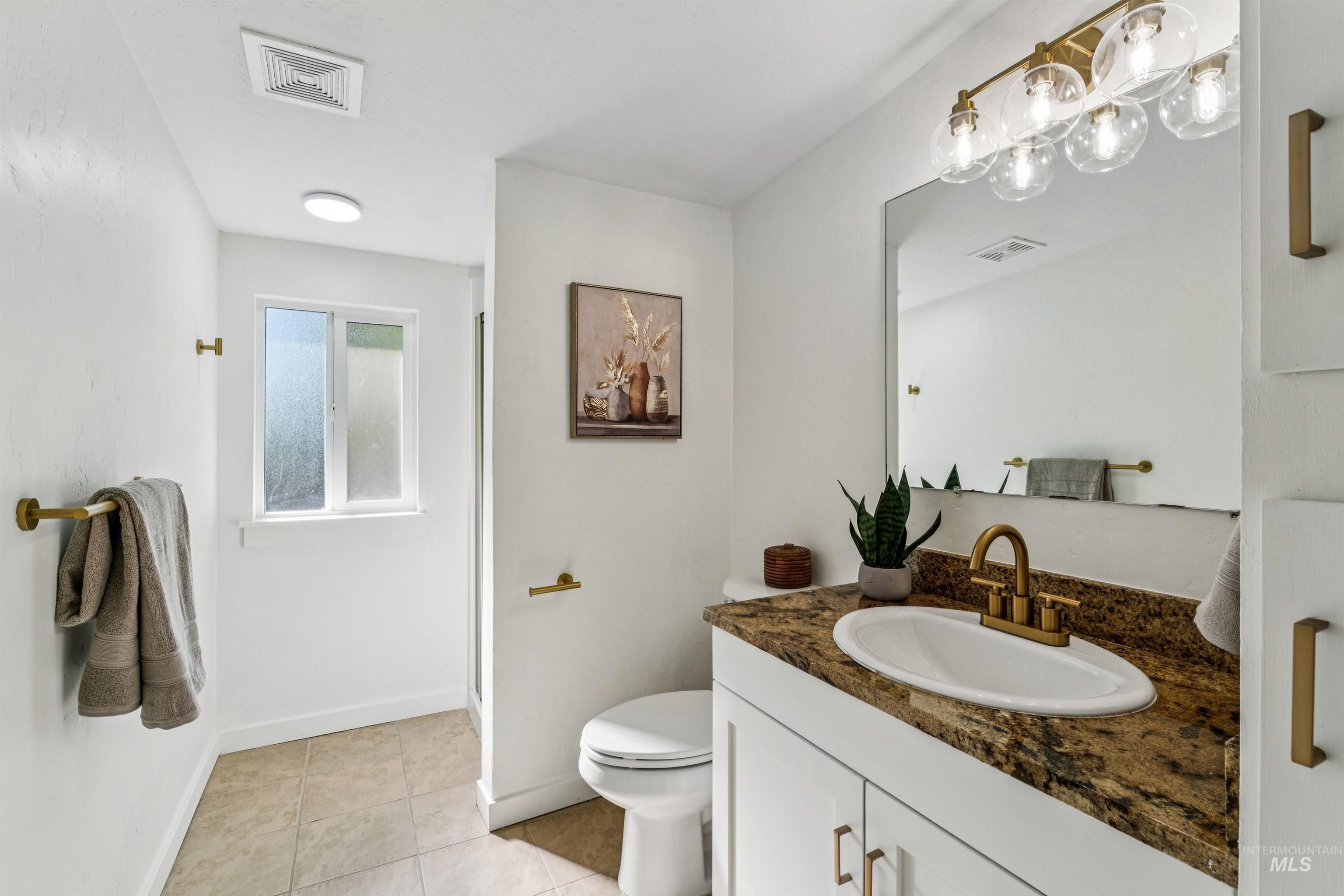 2419 West Hill Road Boise, ID 83702 - Photo 25 of 50 Bathroom with vanity, light tile patterned floors, and a stall shower