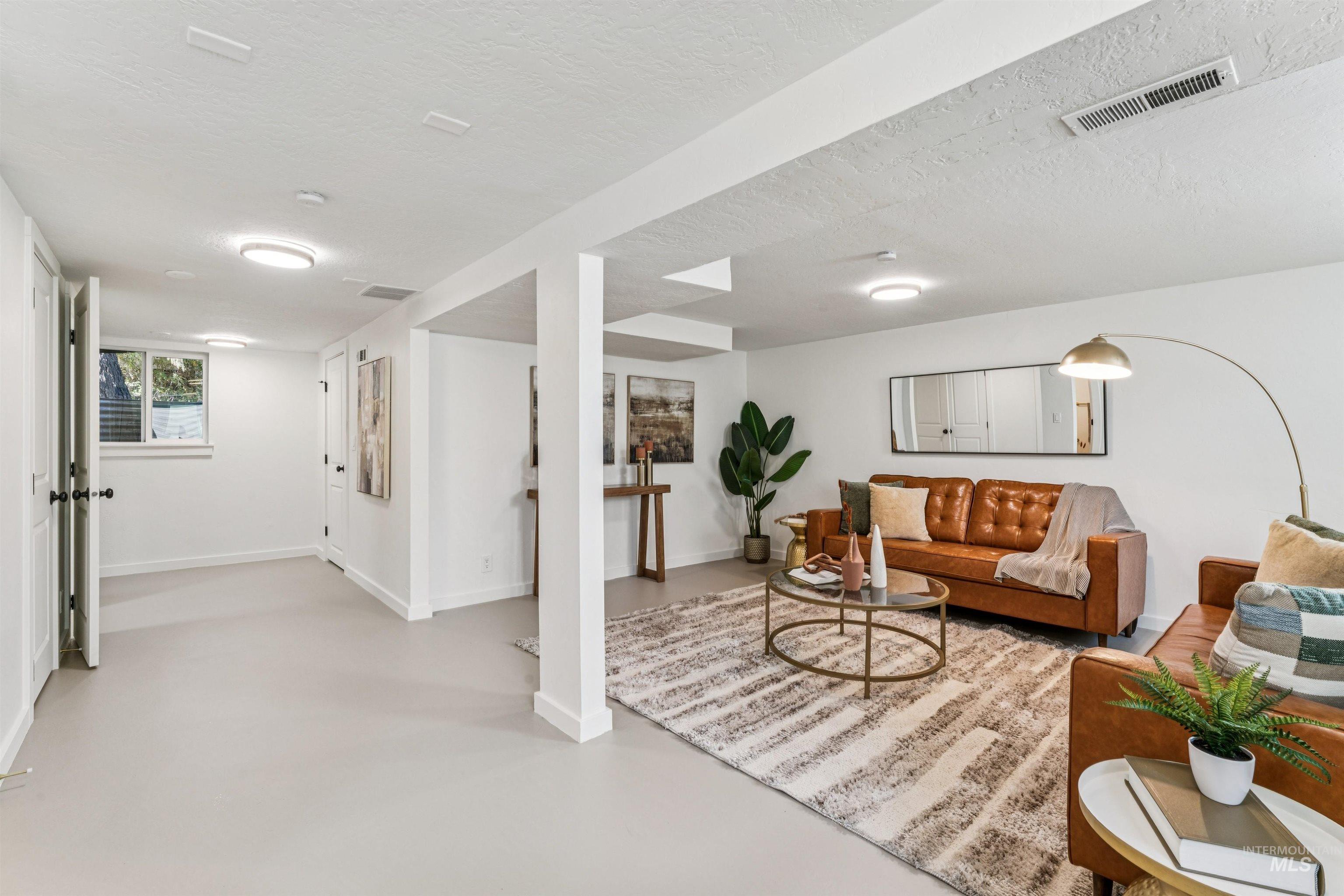 2419 West Hill Road Boise, ID 83702 - Photo 34 of 50 Recreation room featuring concrete flooring and a textured ceiling