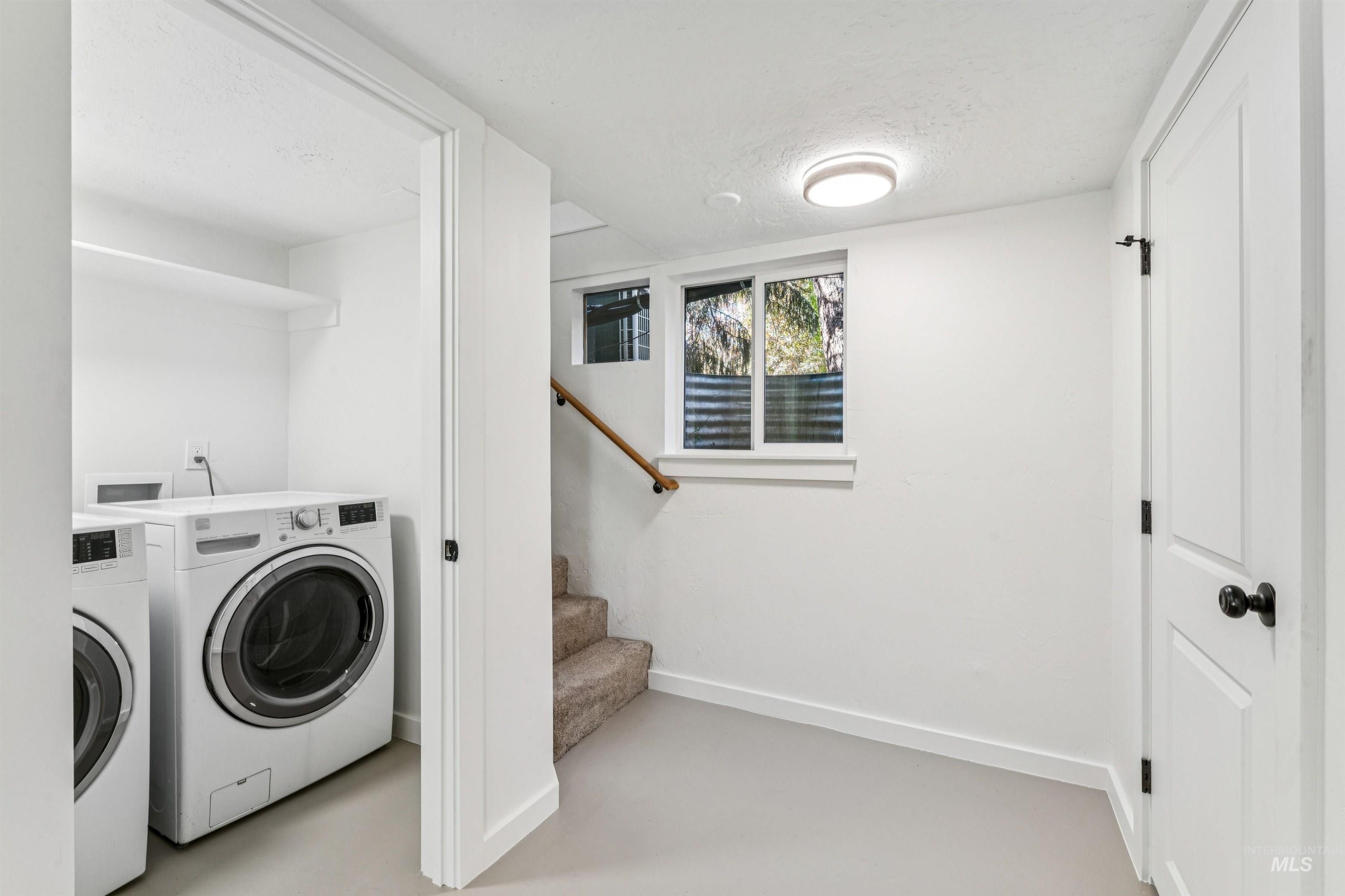 2419 West Hill Road Boise, ID 83702 - Photo 35 of 50 Laundry room featuring finished concrete floors, a textured ceiling, and washing machine and dryer
