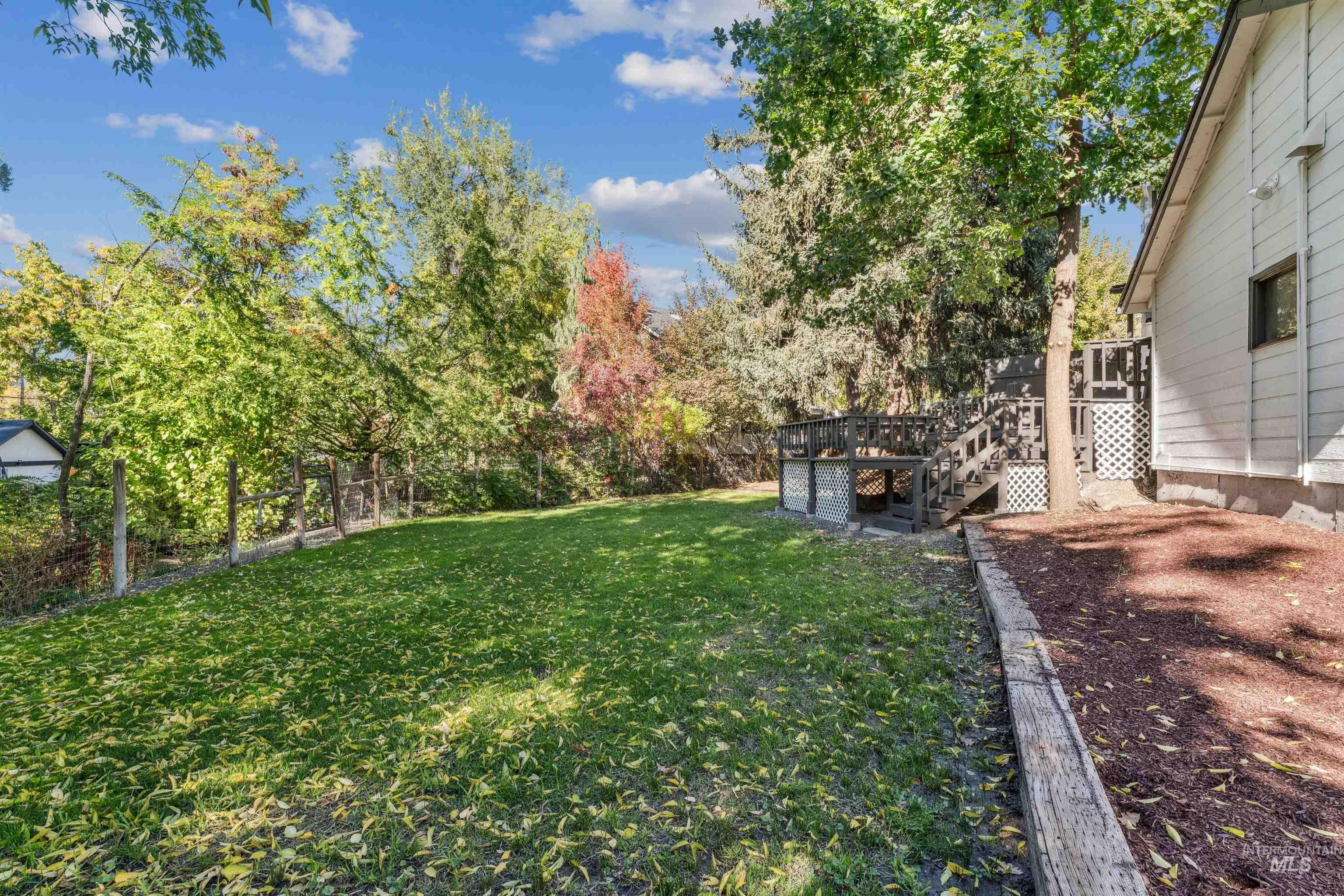 2419 West Hill Road Boise, ID 83702 - Photo 44 of 50 View of grassy yard featuring a deck and stairs