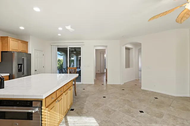a large kitchen with a large counter top appliances and cabinets
