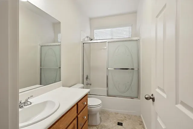 a view of a hallway with wooden floor and windows