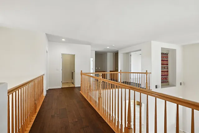 a view of a livingroom with a chandelier fan and a bathroom