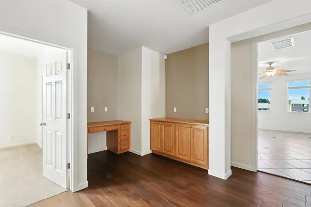 a spacious bathroom with a double vanity sink toilet mirror and bathtub
