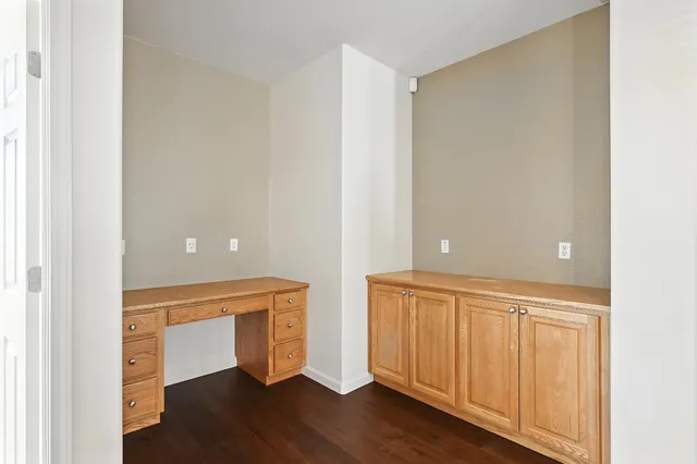 a spacious bathroom with a granite countertop toilet a double vanity sink a mirror and a bathtub