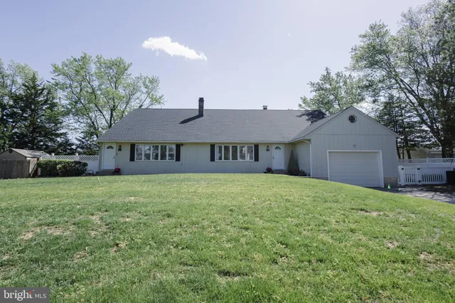 a house with huge green field in front of it