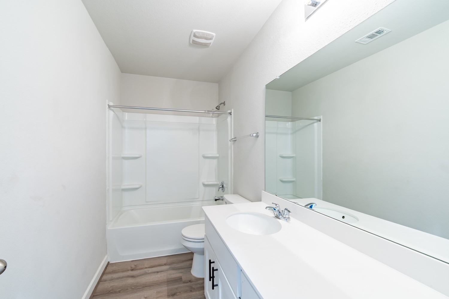 147 Waterside Road, Unit A Buda, TX 78610 - Photo 21 of 27 A well-appointed bathroom features a bright vanity with ample counter space and a classic tub-shower combination.