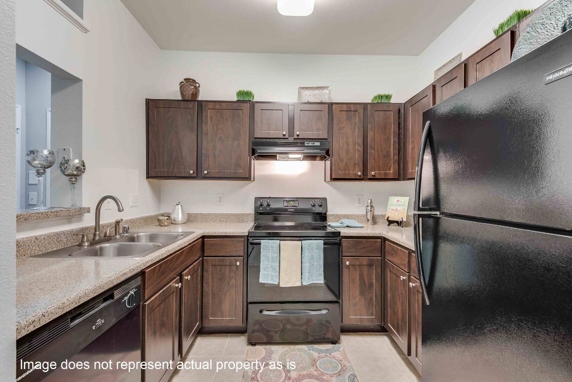 2400-618 Spring Rain Drive Spring, TX 77379 - Photo 10 of 37 a kitchen with stainless steel appliances granite countertop a sink stove and refrigerator