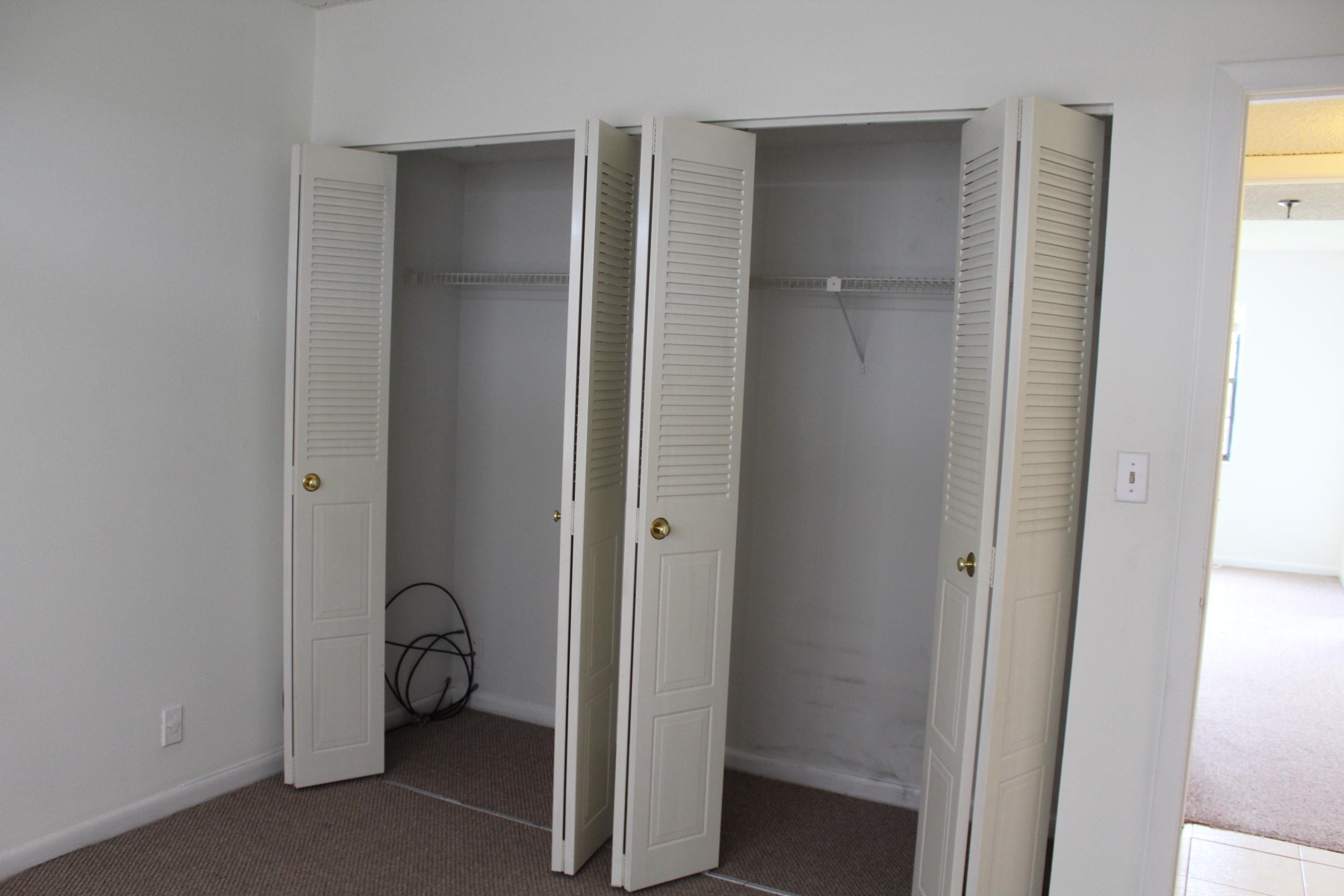 9235 Southwest 8th Street, Unit 503 Boca Raton, FL 33428 - Photo 12 of 27 a view of a room with a door and chair