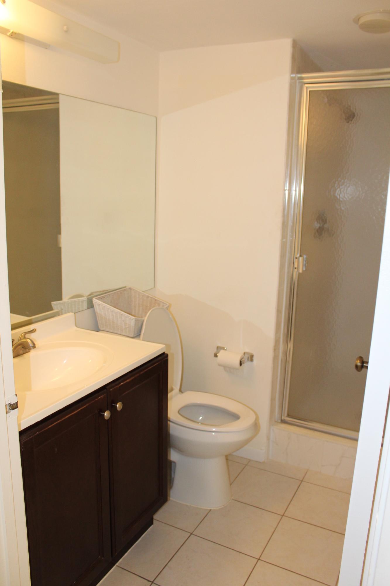 9235 Southwest 8th Street, Unit 503 Boca Raton, FL 33428 - Photo 13 of 27 a bathroom with a sink and a mirror