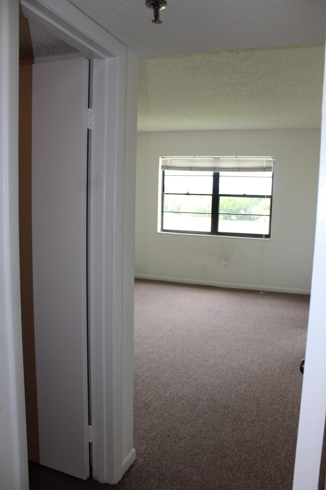 9235 Southwest 8th Street, Unit 503 Boca Raton, FL 33428 - Photo 14 of 27 an empty room with a window