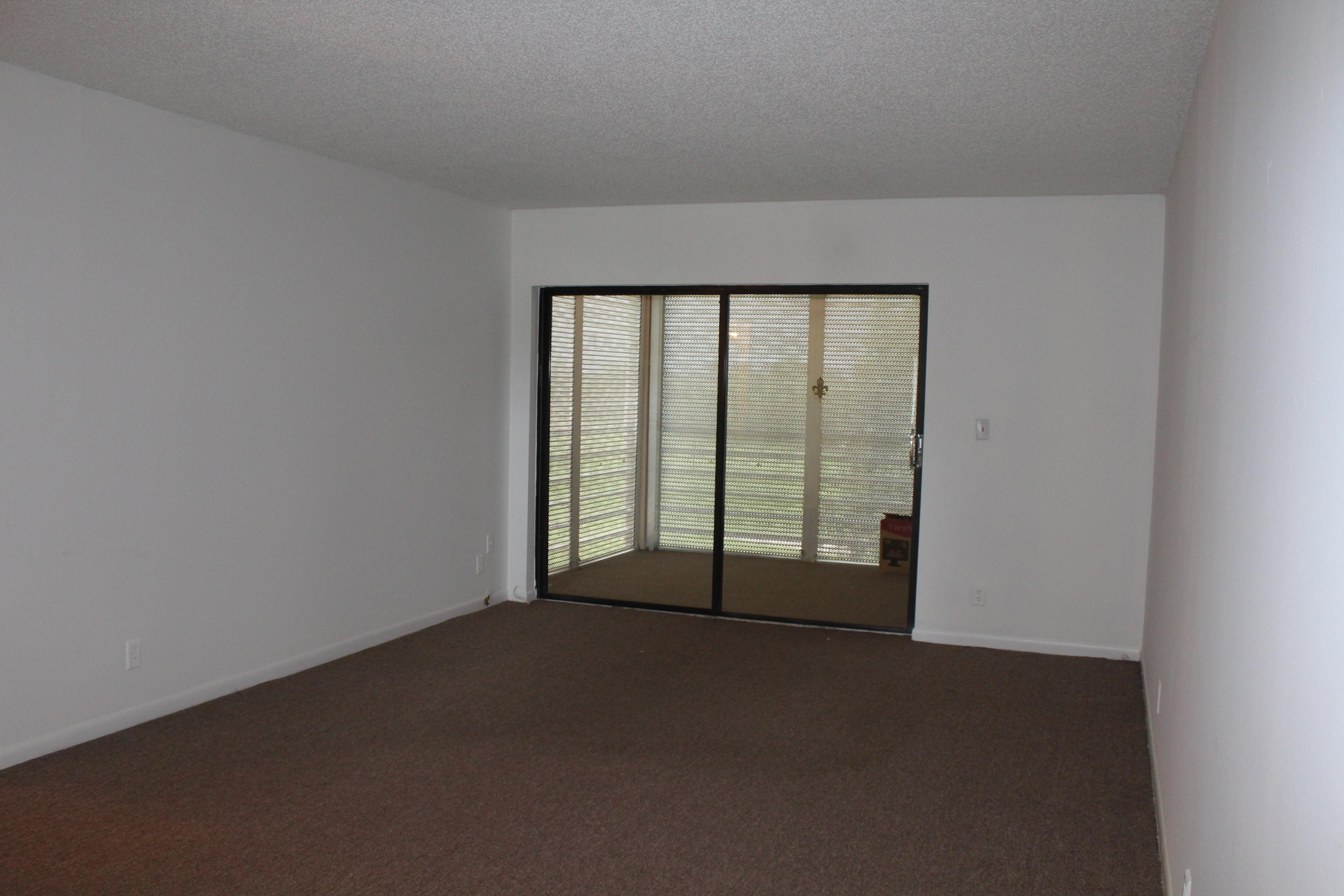 9235 Southwest 8th Street, Unit 503 Boca Raton, FL 33428 - Photo 5 of 27 a view of an empty room with a window