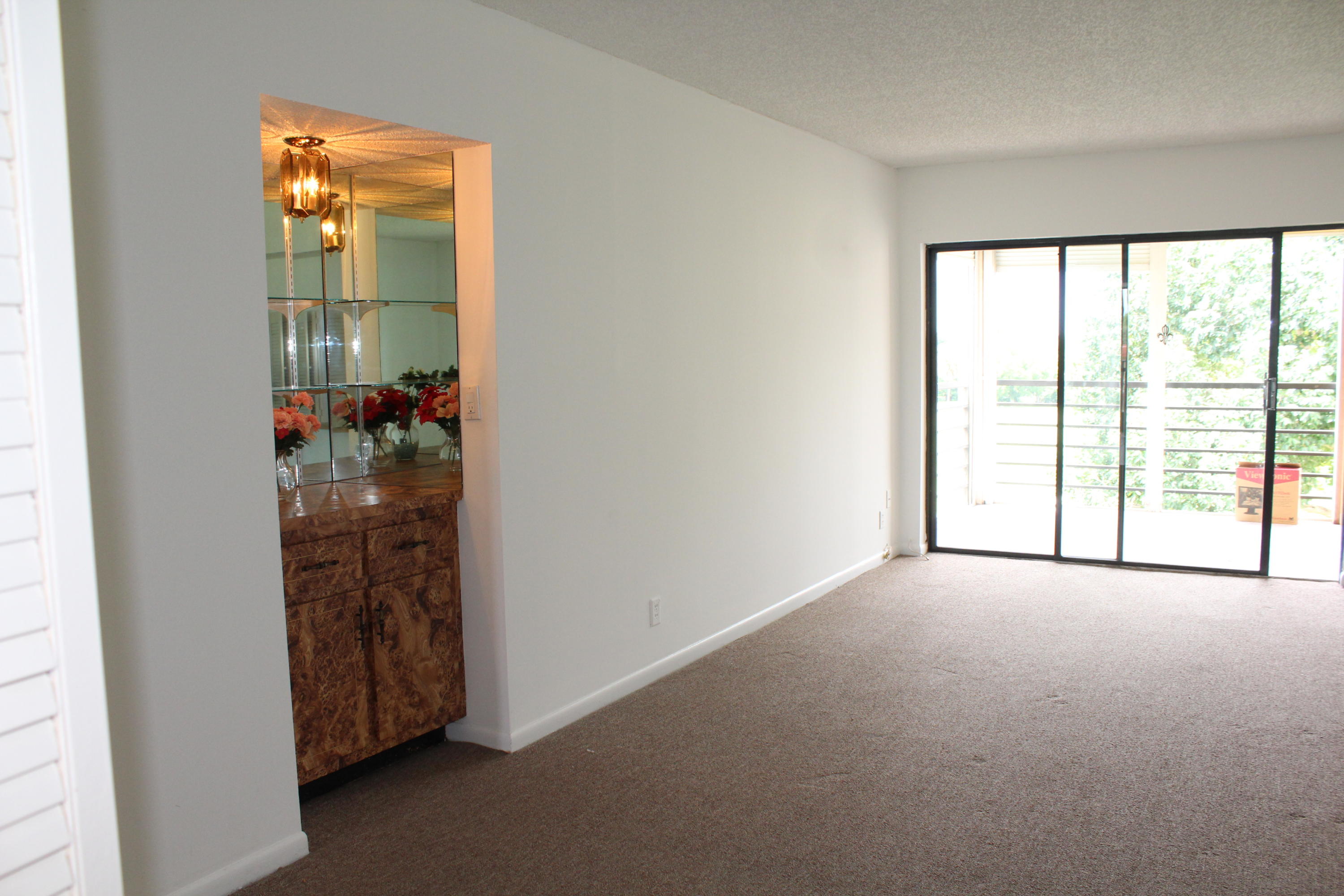 9235 Southwest 8th Street, Unit 503 Boca Raton, FL 33428 - Photo 6 of 27 an empty room with windows and closet