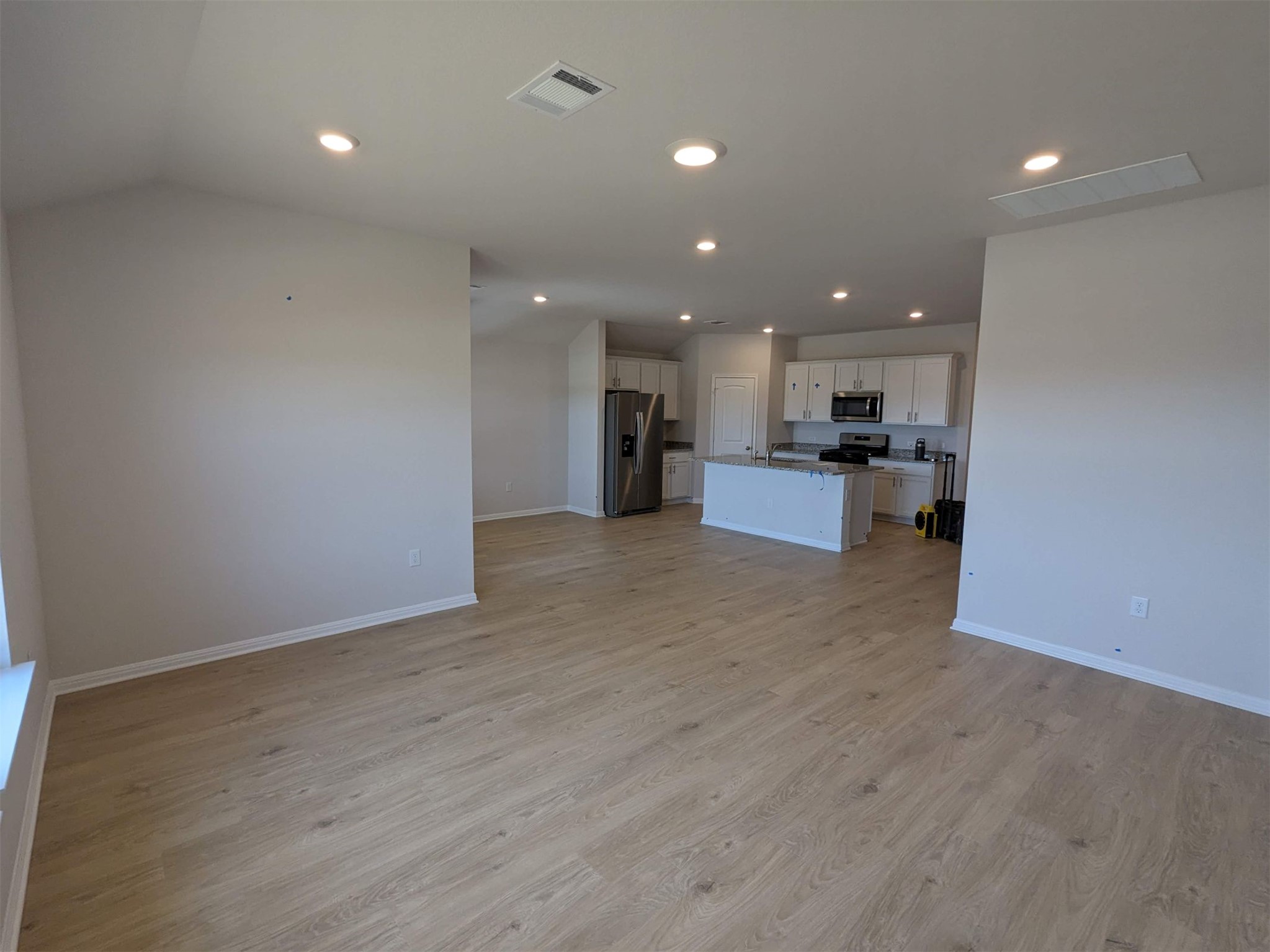 2412 Lightning View Leander, TX 78641 - Photo 2 of 24 A well-lit, open-concept living space with a modern kitchen and light-toned flooring.