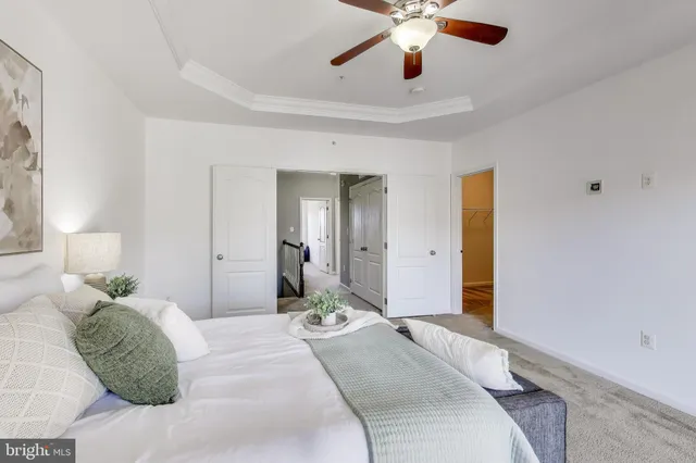 a bedroom with a large bed and a chandelier