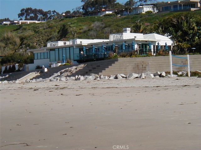 a view of a town with barn and large trees