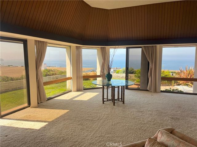 a view of an empty room with large windows