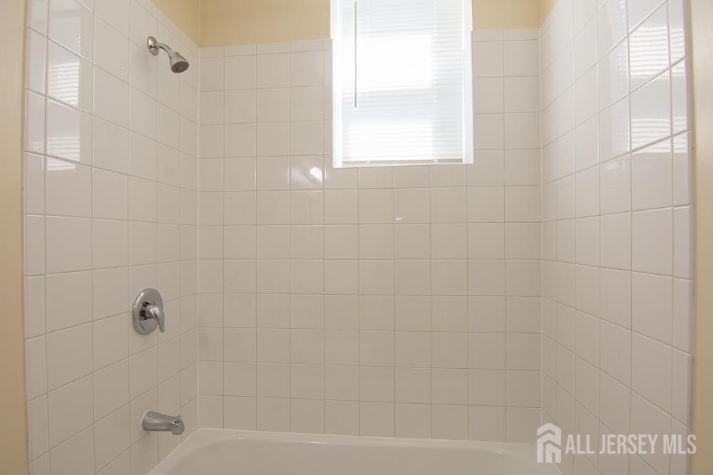 9 Koster Boulevard, Unit A Edison, NJ 08837 - Photo 12 of 15 a bathroom with a bathtub
