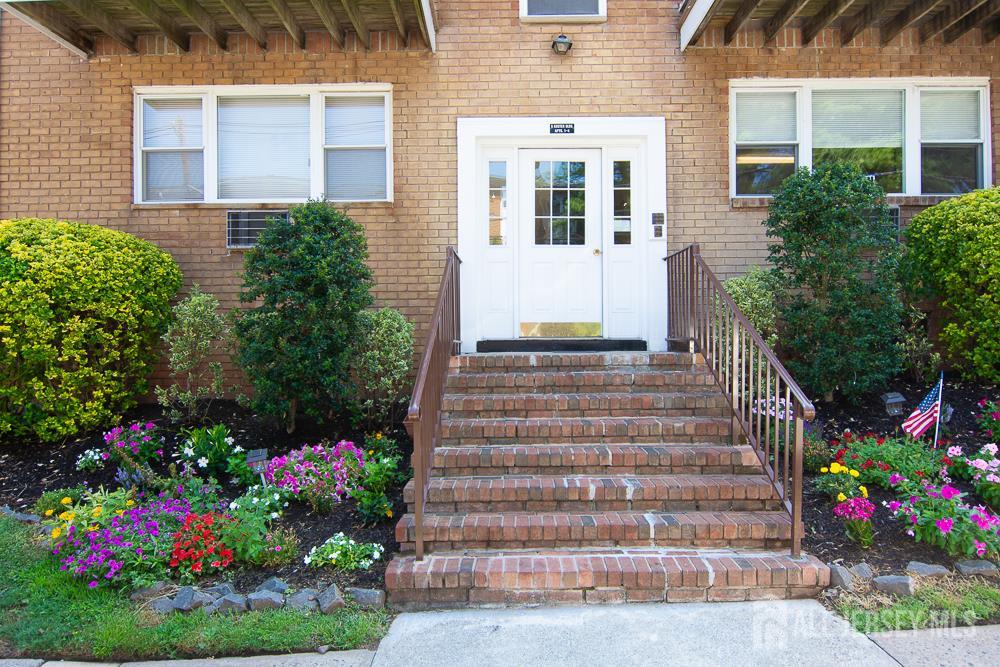 9 Koster Boulevard, Unit A Edison, NJ 08837 - Photo 15 of 15 a front view of building with flowers
