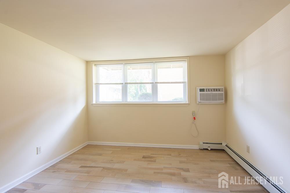 9 Koster Boulevard, Unit A Edison, NJ 08837 - Photo 4 of 15 an empty room with a window