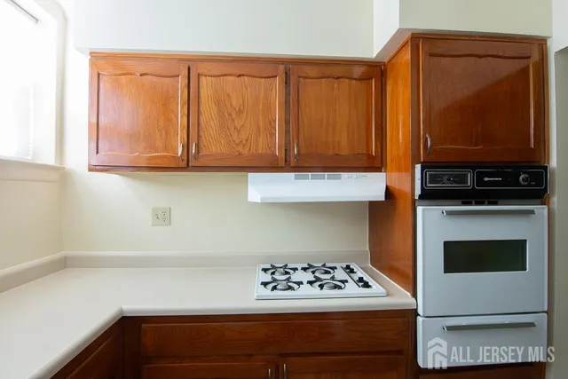 a kitchen with appliances and cabinets