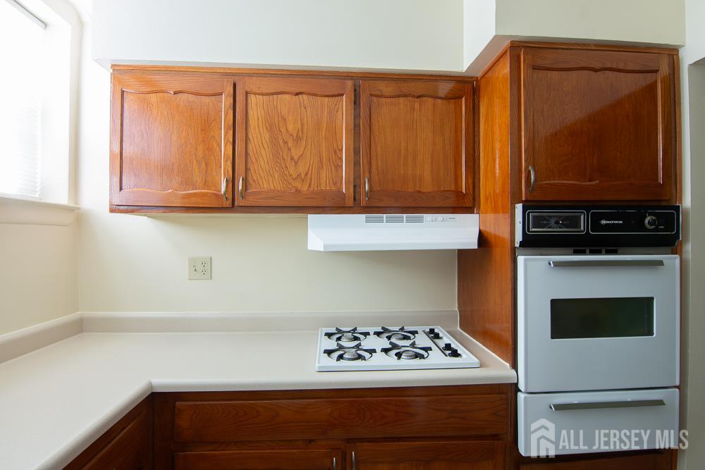 9 Koster Boulevard, Unit A Edison, NJ 08837 - Photo 7 of 15 a kitchen with appliances and cabinets