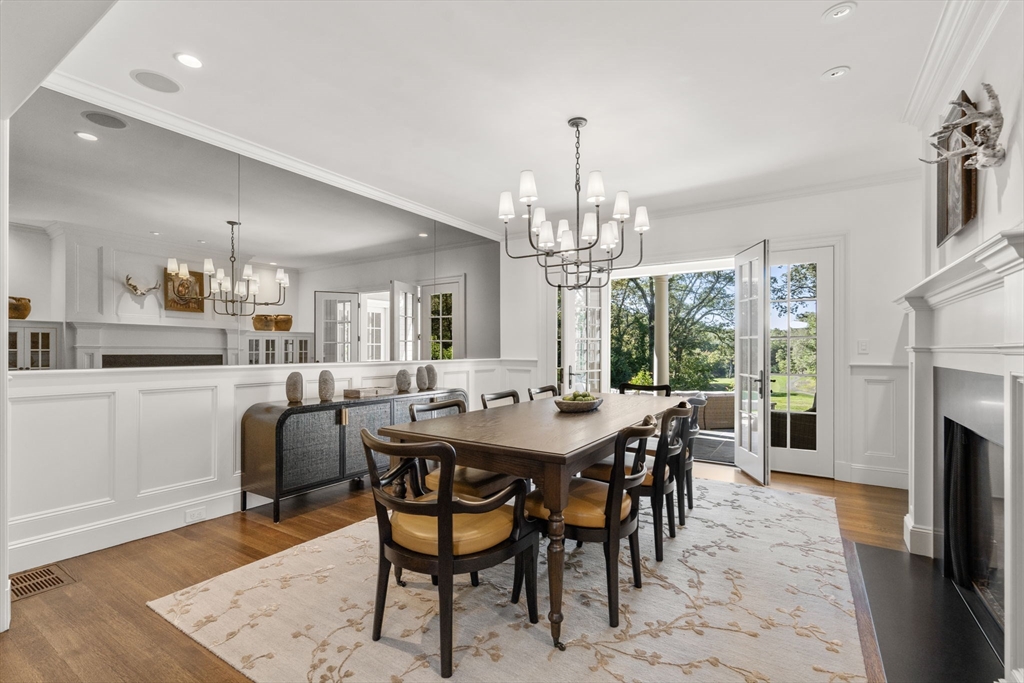 76 Robin Road Weston, MA 02493 - Photo 12 of 25 a view of a dining room with furniture a chandelier and wooden floor