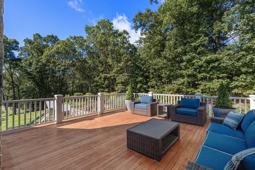 76 Robin Road Weston, MA 02493 - Photo 15 of 25 a balcony with wooden floor and outdoor seating
