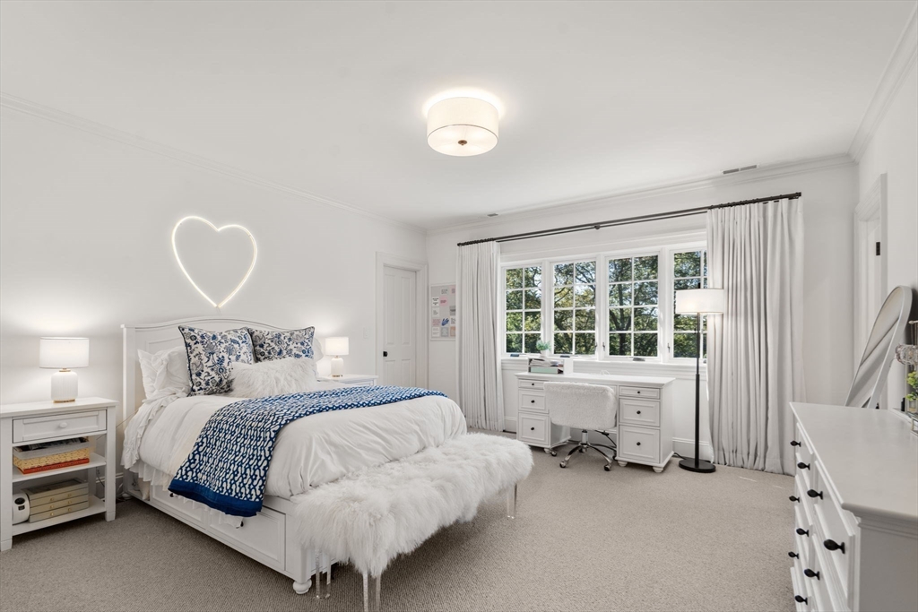 76 Robin Road Weston, MA 02493 - Photo 19 of 25 a bedroom with a bed and a chair