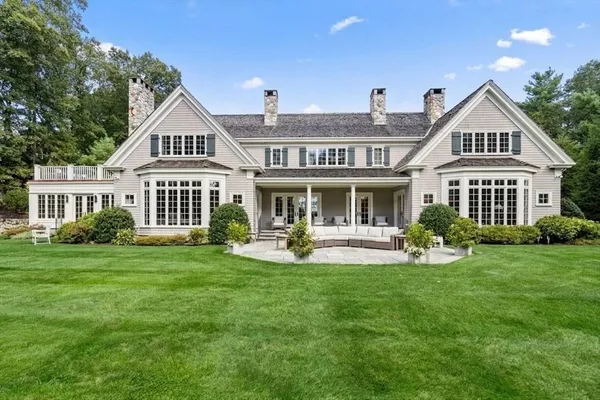 a front view of a house with swimming pool having outdoor seating