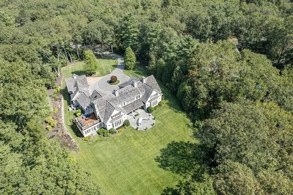 an aerial view of a house with a yard