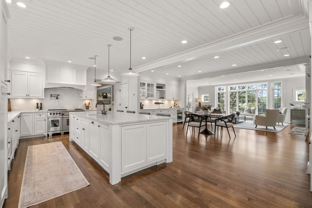 76 Robin Road Weston, MA 02493 - Photo 4 of 25 a large white kitchen with lots of counter space wooden floor and appliances