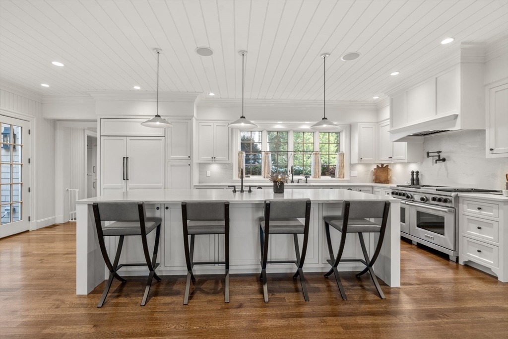 76 Robin Road Weston, MA 02493 - Photo 5 of 32 a kitchen with stainless steel appliances granite countertop a kitchen island a stove and a wooden floors