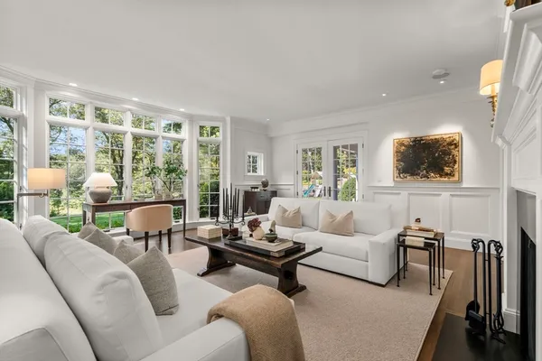 a living room with furniture and a floor to ceiling window